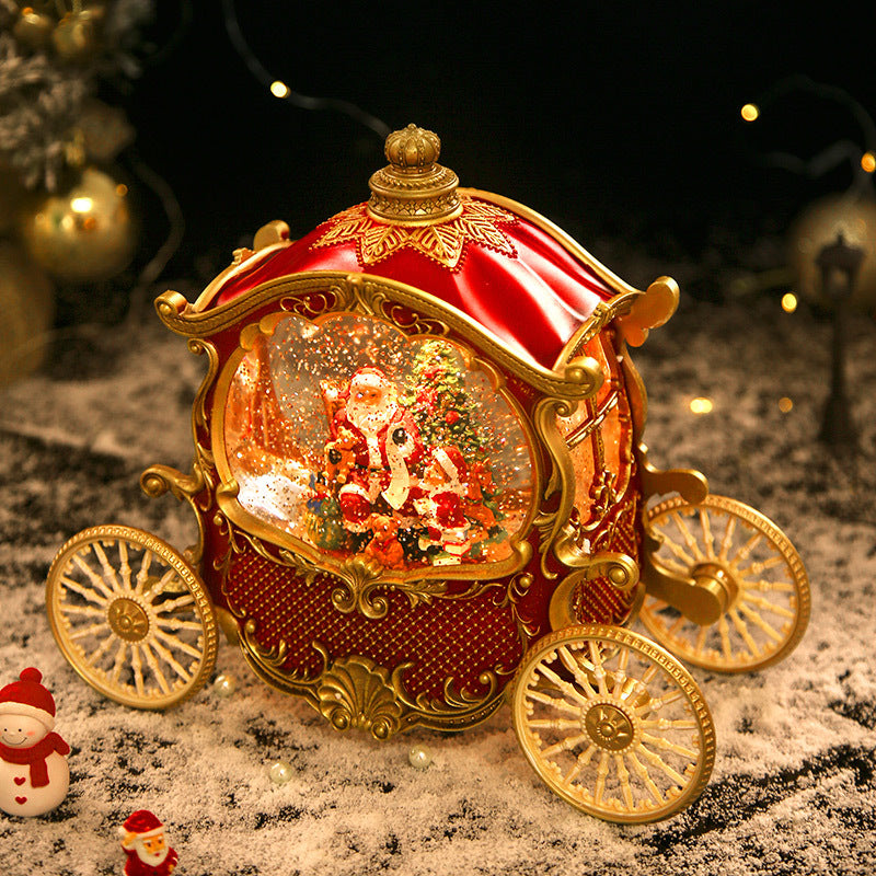Red carriage snow globe in a Christmas display