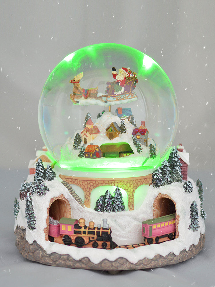 Christmas village snow globe with green lighting