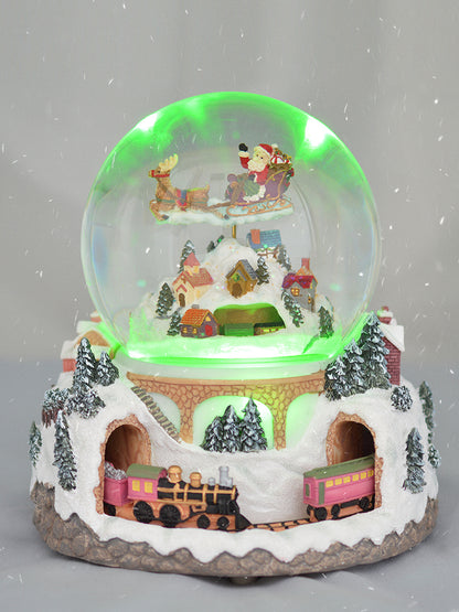 Christmas village snow globe with green lighting