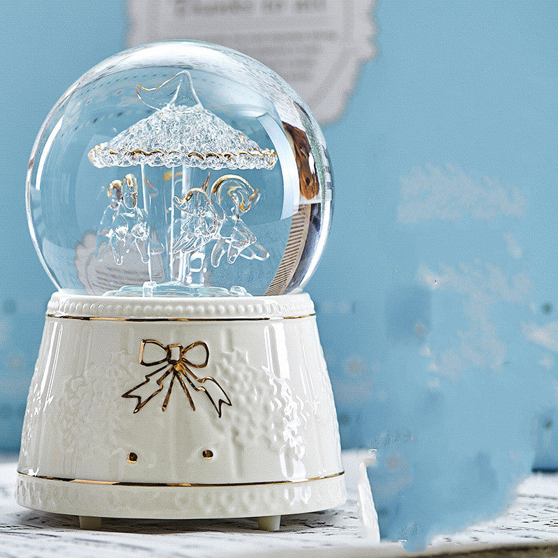 White carousel snow globe with bow detail