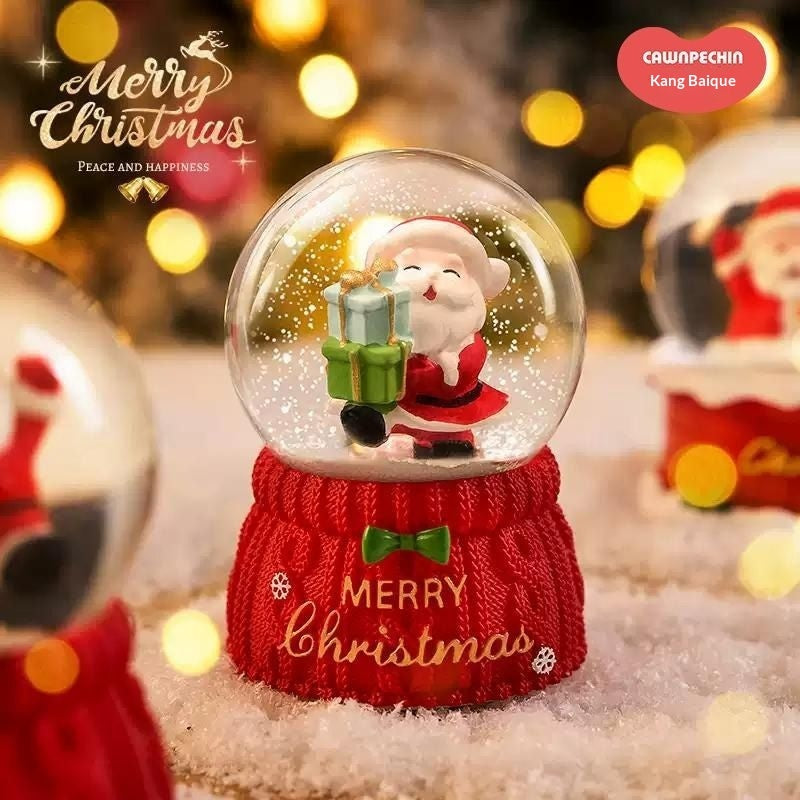 Santa snow globe beside warm holiday lights