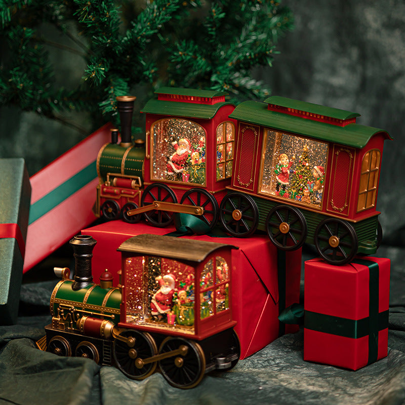 Christmas train decorations displayed beside gifts