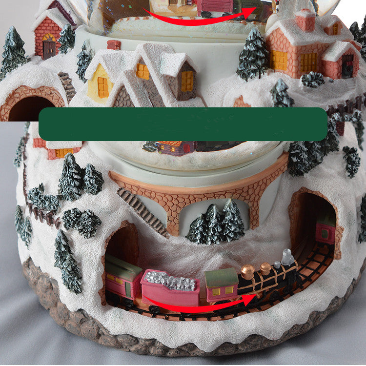 Close-up of miniature train around the snow globe base