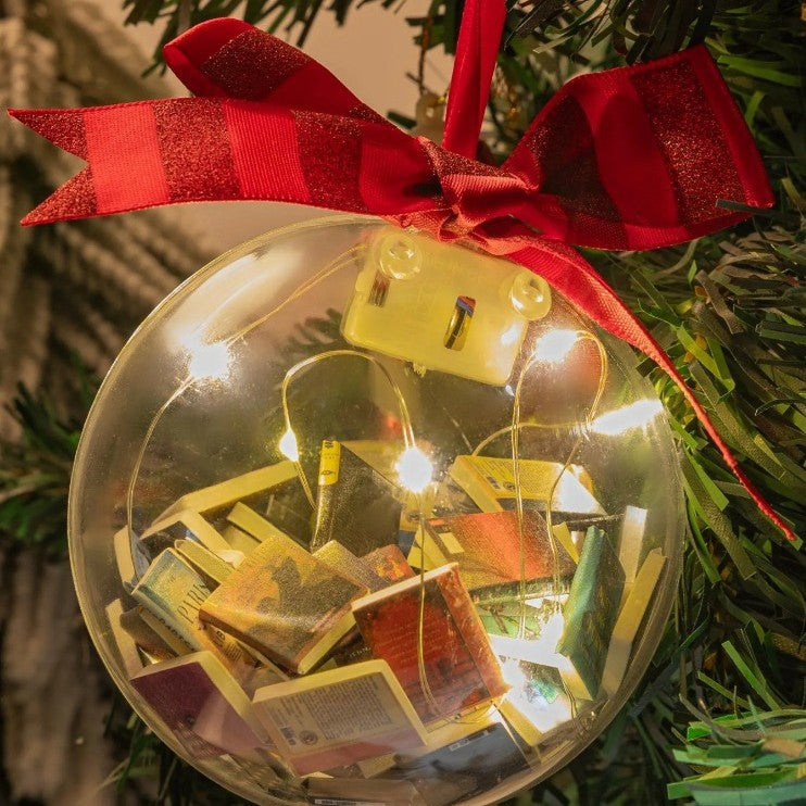 Close-up of tiny decorative books inside a bauble