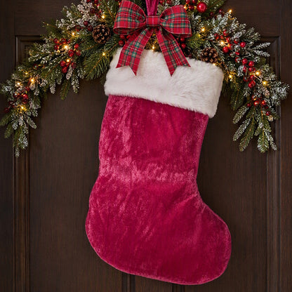 Dark pink stocking on a holiday wreath
