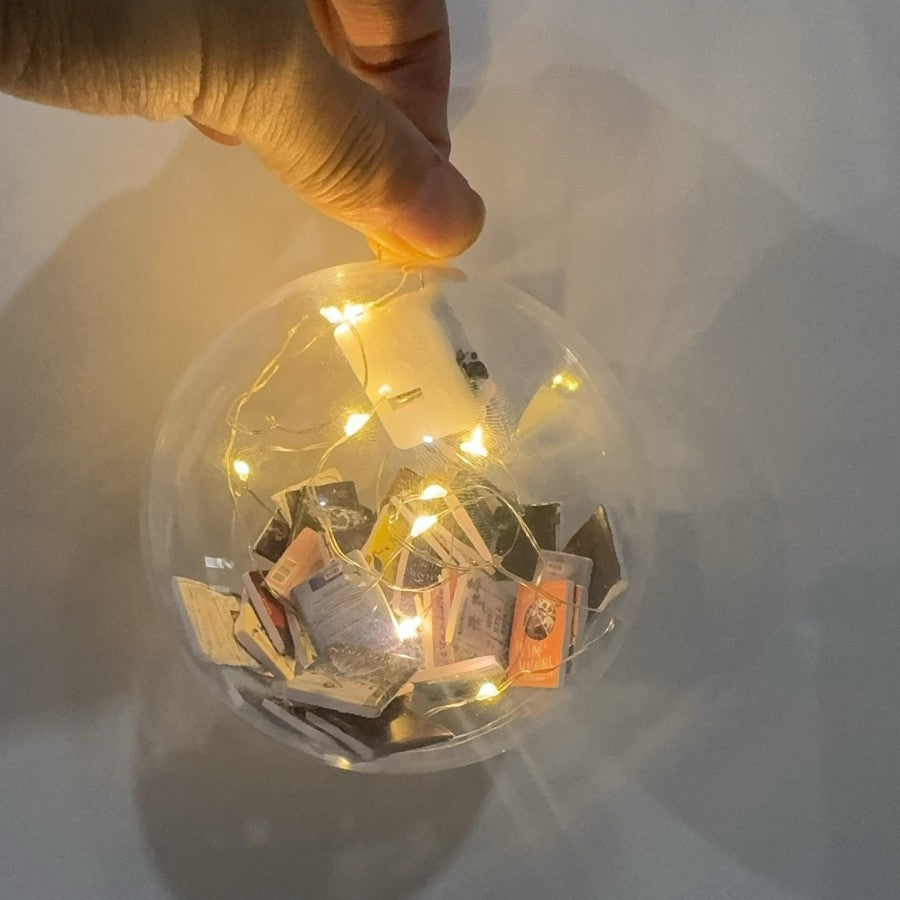 Clear miniature book ornament held by its loop