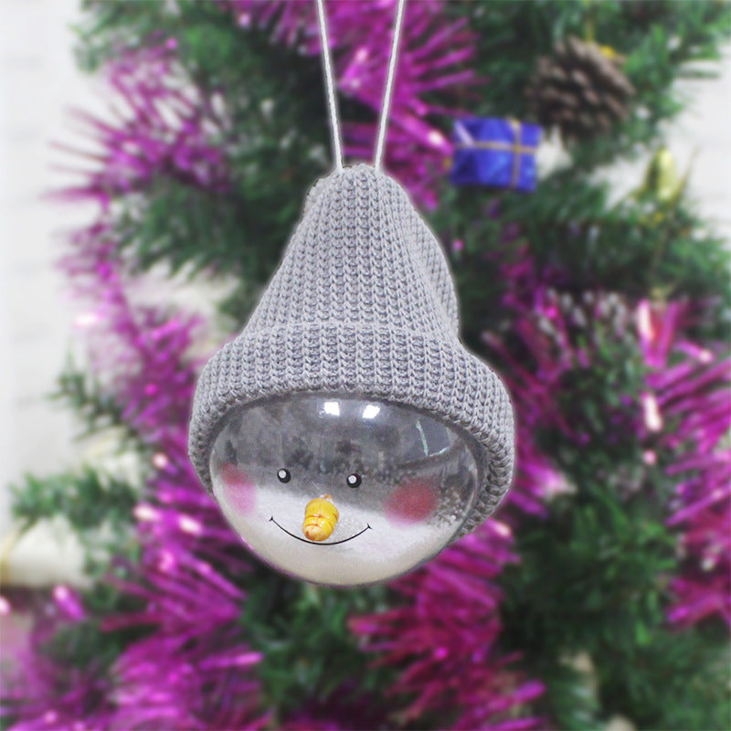 Gray-hat snowman ornament hanging on a tree