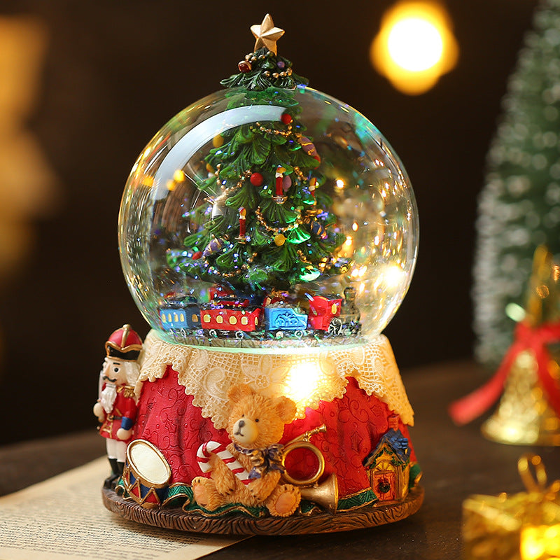 Christmas scene globe on red decorative base
