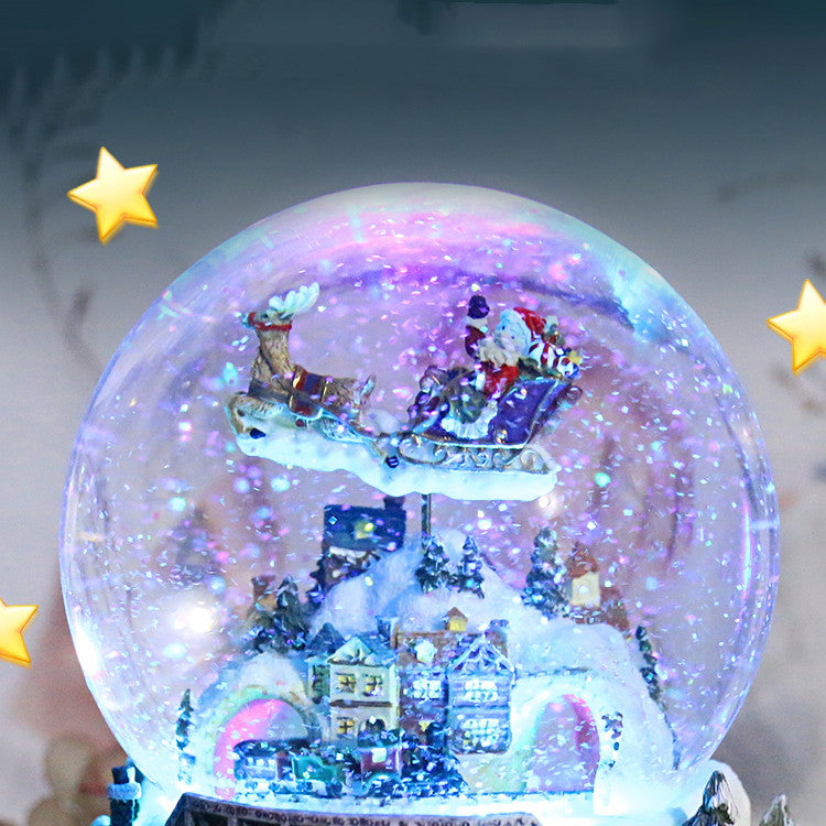Illuminated Christmas village inside a snow globe
