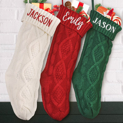Cable-knit stockings with illustrative names in a holiday display