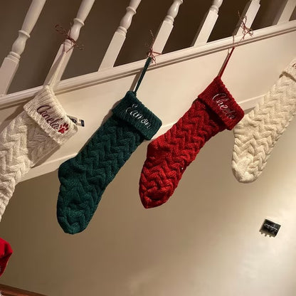 Cable-knit stockings hanging from a staircase