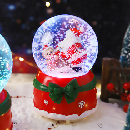 Lighted Santa snow globe on a red gift base