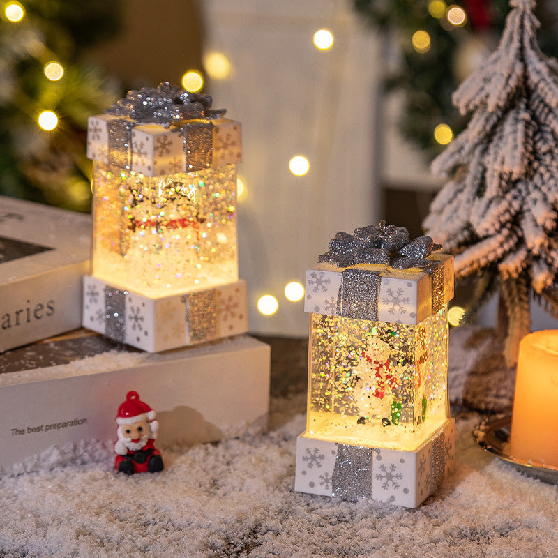 White gift box globes with snowman scenes