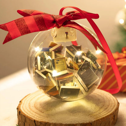 Book-filled bauble with red ribbon on a display stand