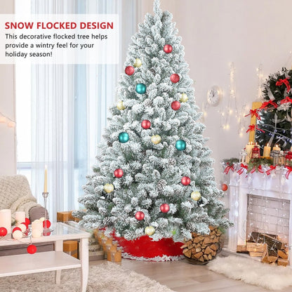 Snow-flocked Christmas tree styled with ornaments and gifts