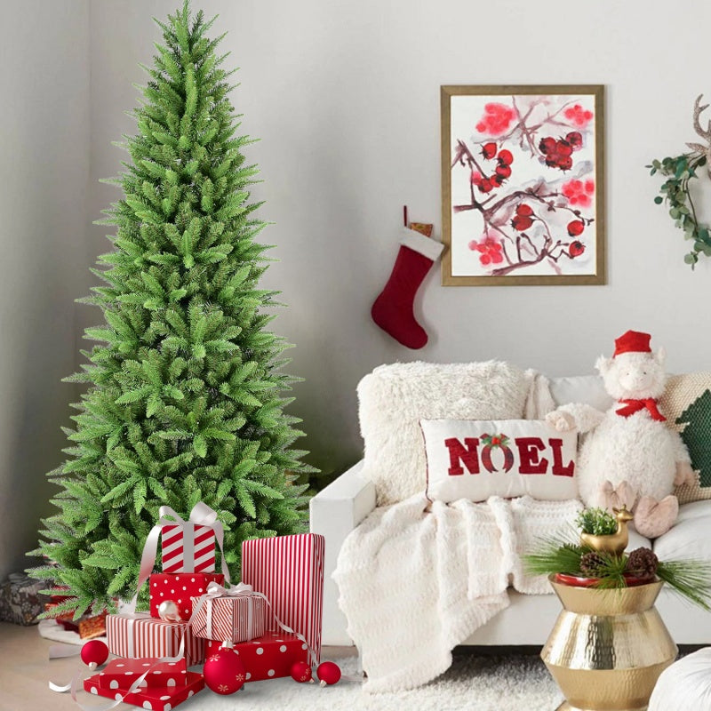 Green artificial Christmas tree beside holiday gifts