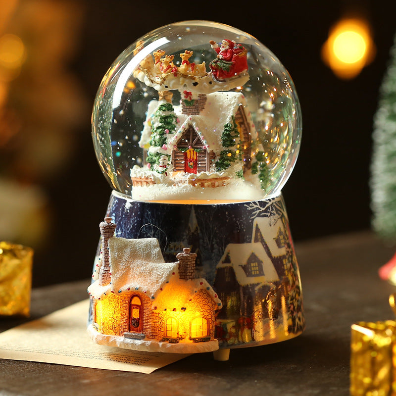 Snow globe with miniature house scene and lighted base