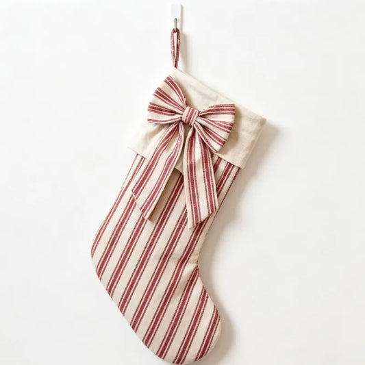Red and white striped Christmas stocking with a large bow
